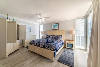 a bedroom with a bed and a ceiling fan at Long Beach 3-0501 ‘Edie's Escape' in Panama City Beach
