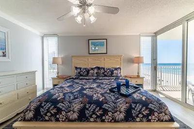 a bedroom with a large bed with a view of the ocean at Long Beach 3-0501 ‘Edie's Escape' in Panama City Beach