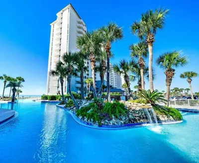a swimming pool with palm trees and a hotel at Long Beach 3-0501 ‘Edie's Escape' in Panama City Beach