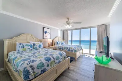 a bedroom with two beds and a tv and a window at Long Beach 3-0501 ‘Edie's Escape' in Panama City Beach