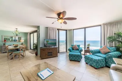 a living room with a view of the ocean at Edgewater 3-0613 'Solace' in Panama City Beach