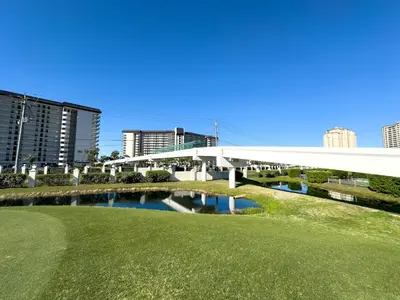a golf course with a bridge over a river at Edgewater 3-0613 'Solace' in Panama City Beach