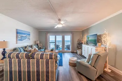 a living room with a couch and two chairs at Mariner West 605 'Flip Flops & Sunsets' in Panama City Beach