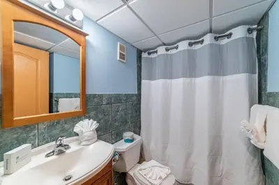 a bathroom with a sink and a shower curtain at Edgewater 3-1009 'Paradise Palms' in Panama City Beach