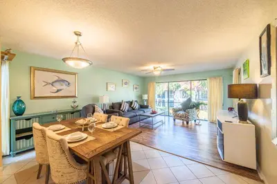 a dining room and living room with a table at Edgewater Villa 0955 'Fountain of Youth' in Panama City Beach