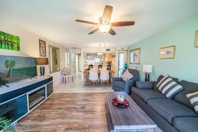 a living room with a couch and a ceiling fan at Edgewater Villa 0955 'Fountain of Youth' in Panama City Beach
