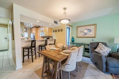 a kitchen and living room with a table and a couch at Edgewater Villa 0955 'Fountain of Youth' in Panama City Beach