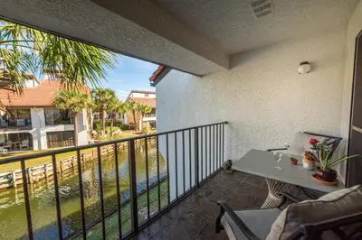 a balcony with a table and a view of the water at Edgewater Villa 0955 'Fountain of Youth' in Panama City Beach