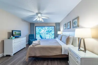 a bedroom with a bed and a ceiling fan at Edgewater Villa 3011 'Fountain View Hideaway' in Panama City Beach