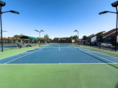 a tennis court with two people on it at Edgewater Villa 3011 'Fountain View Hideaway' in Panama City Beach