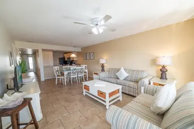 a living room with a couch and a table at Edgewater Villa 3111 'The Salty Oasis' in Panama City Beach