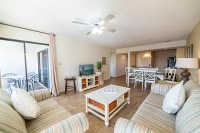 a living room with a couch and a table at Edgewater Villa 3111 'The Salty Oasis' in Panama City Beach