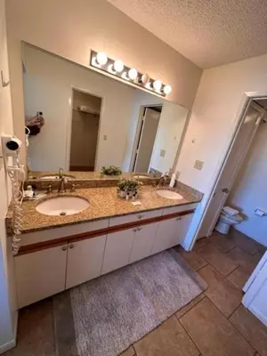 a bathroom with two sinks and a large mirror at Edgewater Villa 3111 'The Salty Oasis' in Panama City Beach