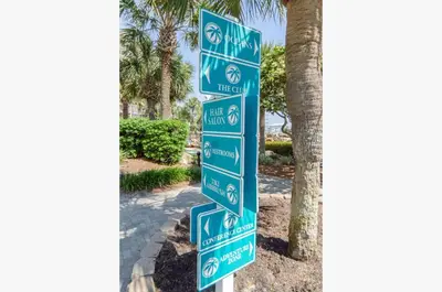 a street sign in front of a palm tree at Edgewater Villa 3111 'The Salty Oasis' in Panama City Beach