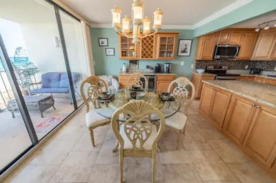 a kitchen with a dining room table and chairs at Edgewater 2-0602 'Beach Blessings' in Panama City Beach