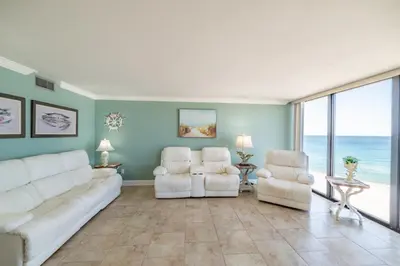 a living room with two white couches and two chairs at Edgewater 2-0602 'Beach Blessings' in Panama City Beach