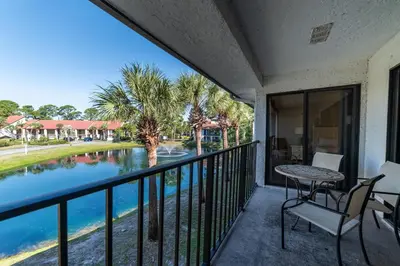 a balcony with a table and chairs and a view of a river at Edgewater Villa 3007 'Anchors Away' in Panama City Beach