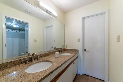 a bathroom with two sinks and a large mirror at Edgewater Villa 3007 'Anchors Away' in Panama City Beach