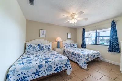 a bedroom with two beds and a ceiling fan at Edgewater Villa 3007 'Anchors Away' in Panama City Beach