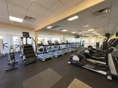 a gym with several treadmills and cardio machines at Edgewater Villa 3007 'Anchors Away' in Panama City Beach