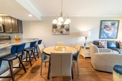 a kitchen and living room with a table and a couch at Edgewater Villa 1510 'Beach & Golf' in Panama City Beach