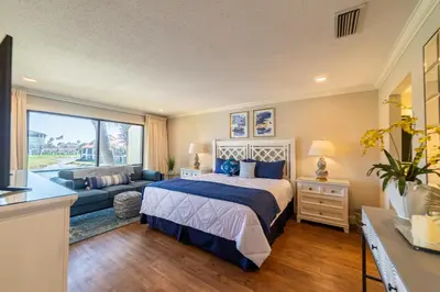 a bedroom with a bed and a couch at Edgewater Villa 1510 'Beach & Golf' in Panama City Beach