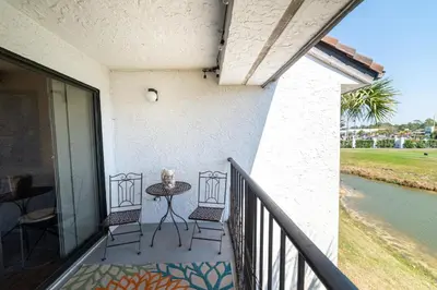 a patio with a table and chairs on a balcony at Edgewater Villa 1510 'Beach & Golf' in Panama City Beach