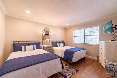 a bedroom with two beds and a window at Edgewater Villa 1510 'Beach & Golf' in Panama City Beach
