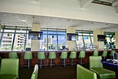 a restaurant with green chairs and a bar with windows at Emerald Beach 2234 'Seas The Dream South' in Panama City Beach