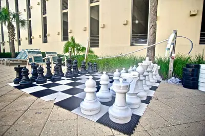 a chess board on a sidewalk with a giant chessboard at Emerald Beach 2234 'Seas The Dream South' in Panama City Beach