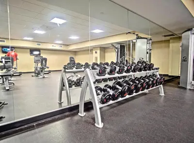 a gym with a large mirror and lots of equipment at Emerald Beach 2234 'Seas The Dream South' in Panama City Beach