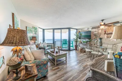 a living room with a couch and a table at Sunbird 1104E 'Flamingo Palms' in Panama City Beach