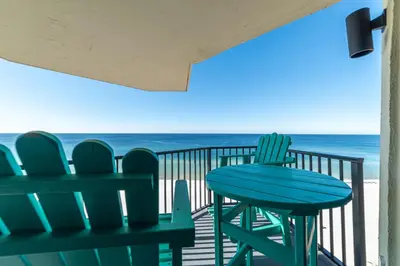a table and chairs on a balcony with the beach at Sunbird 1104E 'Flamingo Palms' in Panama City Beach