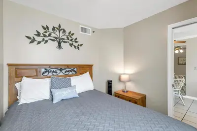 a bedroom with a bed with a wooden head board at Sunbird 807E in Panama City Beach