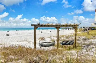 two benches on a beach with the ocean in the background at Sunbird 807E in Panama City Beach