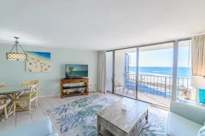 a living room with a view of the ocean at Edgewater 1-0708 'Beach Happy' in Panama City Beach