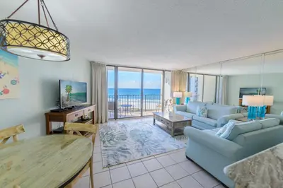 a living room with a couch and a table at Edgewater 1-0708 'Beach Happy' in Panama City Beach