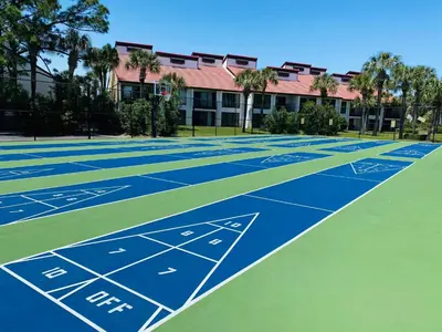 a tennis court in front of a building at Edgewater 3-0905 'Gone Coastal' in Panama City Beach
