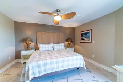 a bedroom with a bed and a ceiling fan at Edgewater 3-0905 'Gone Coastal' in Panama City Beach