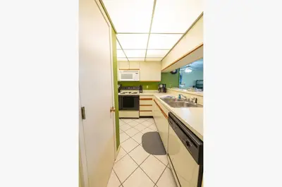 a kitchen with a sink and a stove at Edgewater Villa 3005 'Paradise Palms' in Panama City Beach