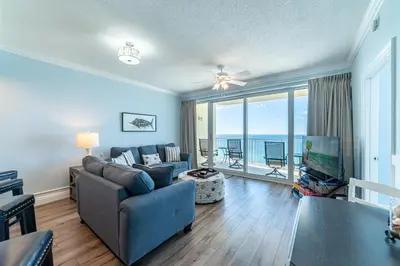 a living room with a couch and a tv at Boardwalk 1409 'Emerald Ray' in Panama City Beach