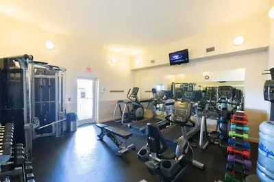 a gym with treadmills and machines in a room at Treasure Island 2004 'Pineapple Paradise' in Panama City Beach