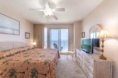 a bedroom with a bed and a flat screen tv at Treasure Island 2004 'Pineapple Paradise' in Panama City Beach