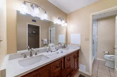 a bathroom with two sinks and a toilet at Edgewater Villa 1303 'Gone Gulf'N' in Panama City Beach