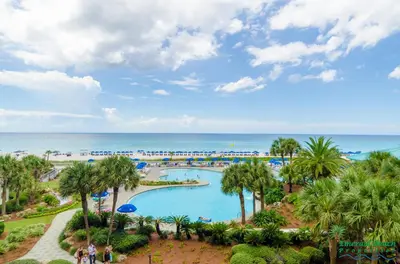 a view of the pool at a resort with the ocean in the background at Edgewater Villa 1303 'Gone Gulf'N' in Panama City Beach