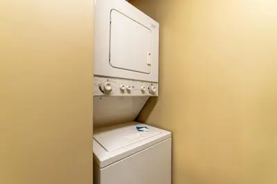 a washing machine with a mirror on top of it at Edgewater Villa 1303 'Gone Gulf'N' in Panama City Beach