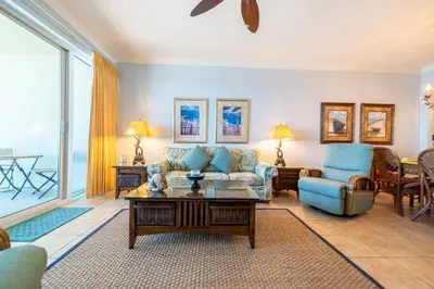 a living room with a couch and a table at Boardwalk 0810 'Endless Summer' in Panama City Beach