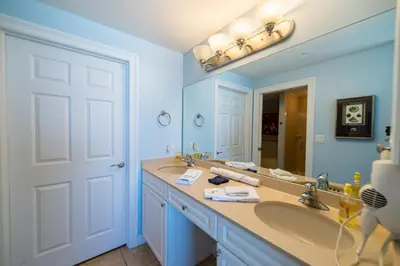 a bathroom with two sinks and a large mirror at Boardwalk 0810 'Endless Summer' in Panama City Beach