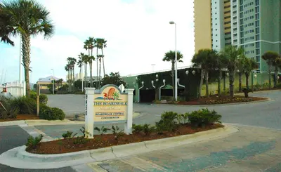 a sign for a hotel on a street with palm trees at Boardwalk 0810 'Endless Summer' in Panama City Beach