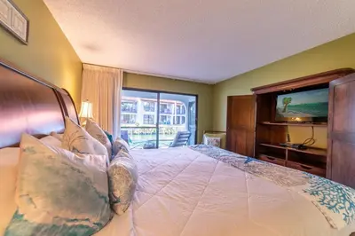 a bedroom with a large bed and a television at Edgewater Villa 2205 'Turtle Dunes' in Panama City Beach
